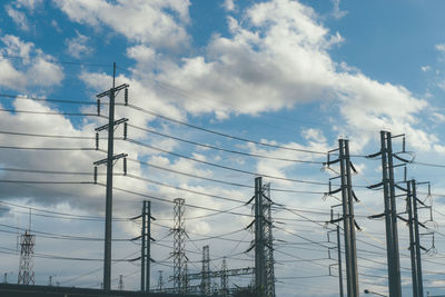 Low angle view of electricity pylon against sky
