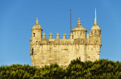 Low angle view of belem tower against clear blue sky