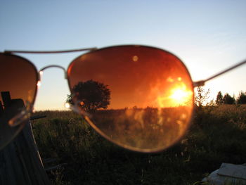 Scenic view of field against clear sky during sunset