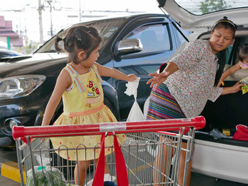 Full length of girl and woman in car