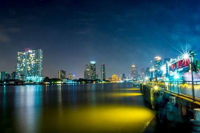 Illuminated city at waterfront