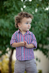 Cute boy standing outdoors