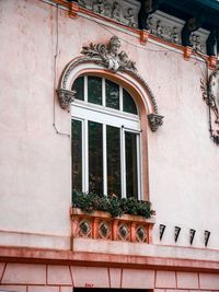 Low angle view of window on wall of building