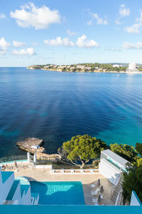 High angle view of swimming pool by sea against sky