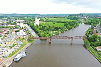 High angle view of bridge over river amidst buildings in city