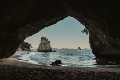 Scenic view of sea seen through cave