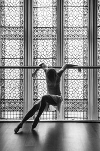 Woman looking through window