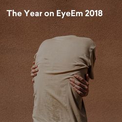 Rear view of people standing against wall