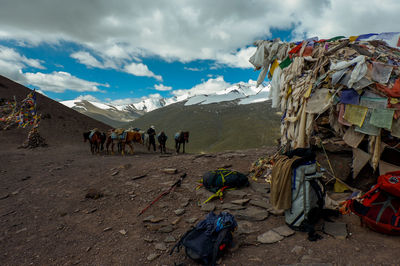 Group of people on mountain road against sky