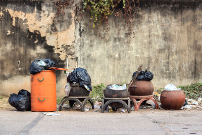 Garbage can against wall in city