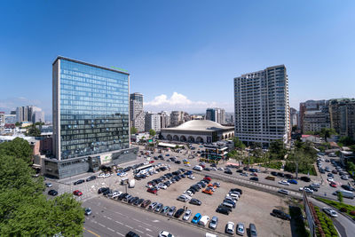 High angle view of buildings in city against clear blue sky
