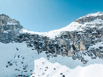 Scenic view of snowcapped mountains against clear sky