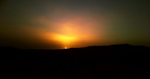 Scenic view of silhouette mountain against sky during sunset