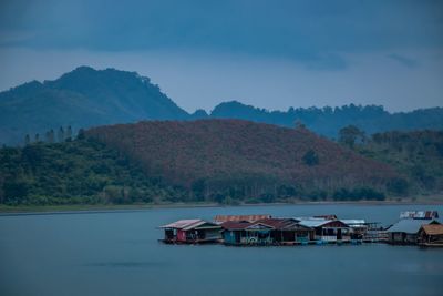 Scenic view of lake and mountains against sky