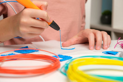 Teen girl using 3d pen. robotics. steam, stem education. modern technologies. play and study at home