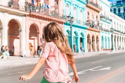 Woman walking on street in city