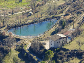 High angle view of tree and buildings against mountain