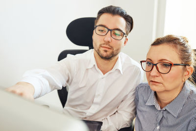 Business people discussing data on computer screen. workmates working hard together. cooperation