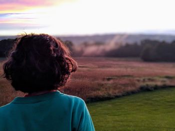 Rear view of woman looking at field