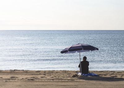 Rear view of people on beach