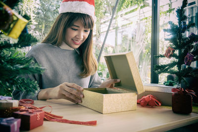 Woman with gift at table during christmas