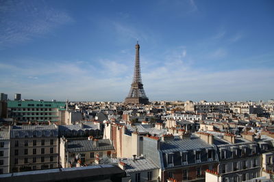 Eiffel tower in city against sky