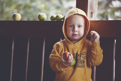 Portrait of cute boy standing outdoors