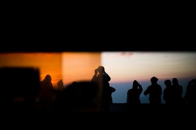 Silhouette of people in dark room