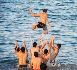 Woman jumping in sea