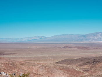 Scenic view of desert against clear blue sky