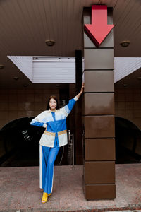 Portrait of man standing against building