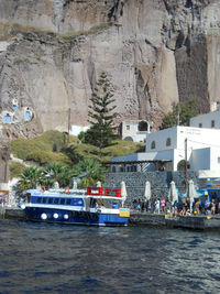 Nautical vessel on rocks by sea