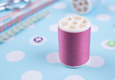 Close-up of thread spool on table