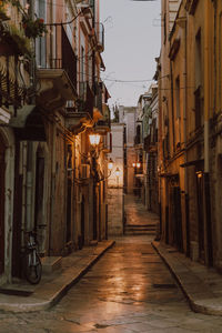 Empty alley amidst buildings in city