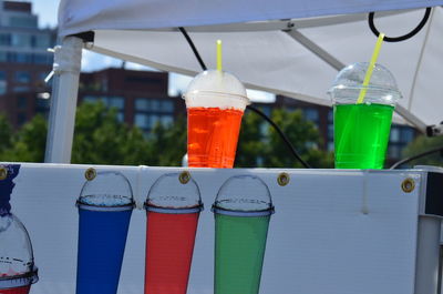 Close-up of fresh drink in disposable cups at market stall