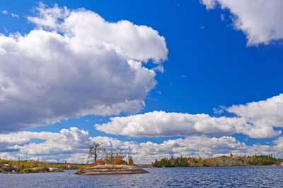 Panoramic view of sea against blue sky