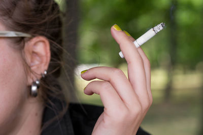 Cropped image of woman smoking cigarette