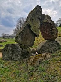 Rocks on field against sky