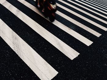 Zebra crossing sign on road in city