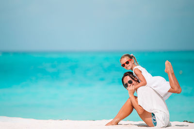 People on beach against sky