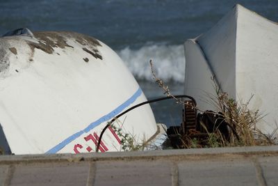 Close-up of metal railing by sea