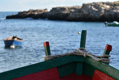 Close-up of moored in sea against sky