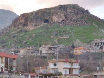 Houses on mountain against sky