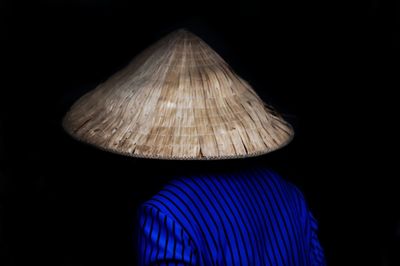 Rear view of illuminated hat against black background