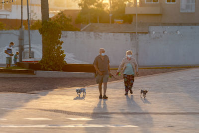 People walking with dog on street