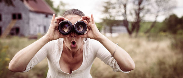 Young woman looking through lenses