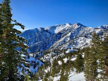 Scenic view of snowcapped mountains against clear blue sky