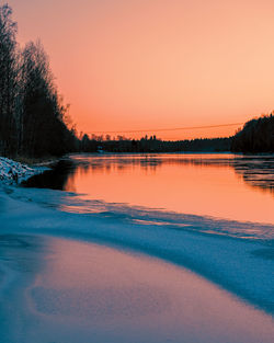 Scenic view of lake against romantic sky at sunset