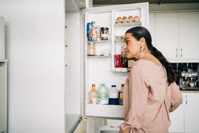 Mid adult woman standing at home