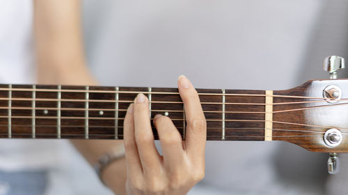 Cropped image of man playing guitar